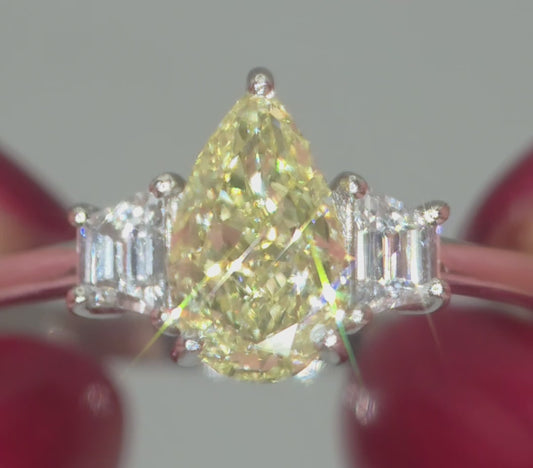 Platinum, 1.24ct VVS1, Pear Cut Yellow Diamond & 0.28 VVS2-VS1 Trapezoid White Diamond Ring. Size S. Includes a GIA Report.