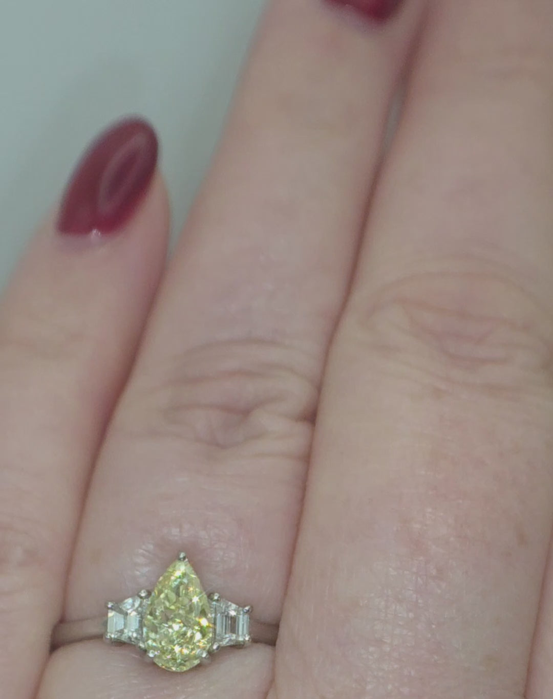 Platinum, 1.24ct VVS1, Pear Cut Yellow Diamond & 0.28 VVS2-VS1 Trapezoid White Diamond Ring. Size S. Includes a GIA Report.